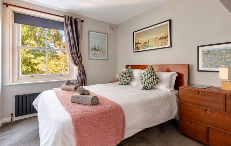 Master Bedroom with king-size bed, artwork, chest of draws and wardrobe.