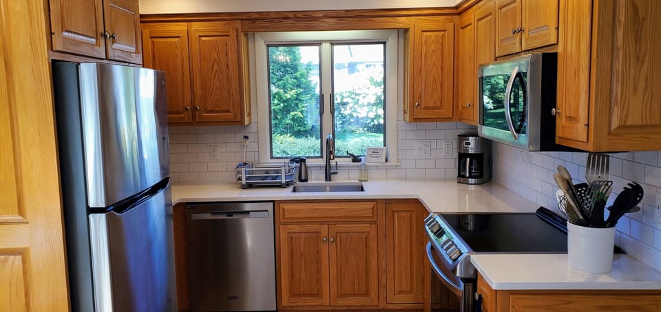 The kitchen has been refreshed with new quartz countertops, sink and backsplash