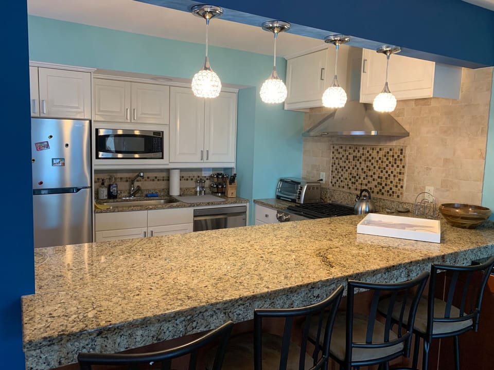 Enjoy your meals on the high granite counter bar with four new barstools