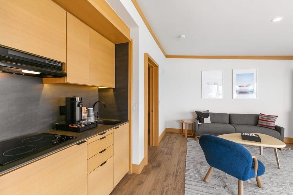 A fully stocked kitchenette with mini-fridge and freezer, cooktop, coffee station with pods, toaster oven, kettle and Ninja blender.