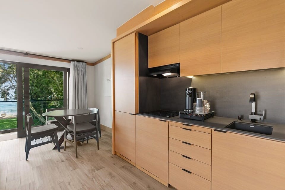 Kitchenette with mini-fridge and freezer, cooktop, Nespresso Vertuo coffee station with pods, toaster oven, iron tea kettle and Ninja blender.