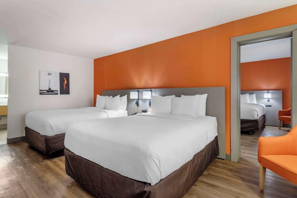 Hypo-allergenic bedding, desk, laptop workspace, blackout drapes