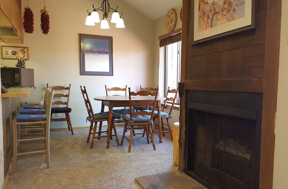 Fireplace in living room opens to dining area
