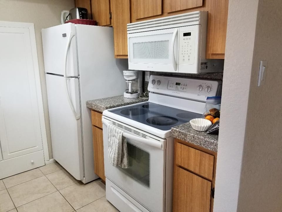 Fully-equipped kitchen. Pots and pans, spices and cooking oil, paper towels.
