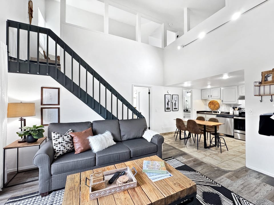 The condo’s high ceilings and natural, organic touches create an airy and inviting atmosphere.