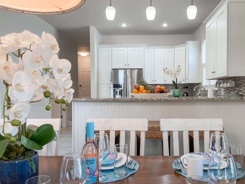 Three additional barstools overlook a gourmet kitchen and a large pantry.