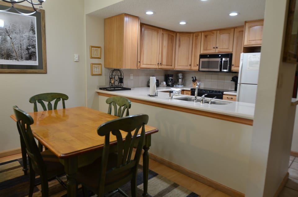 Dining Area and Fully-Equipped Kitchen - The dining area has a nice dining room table for all guests to enjoy. The fully-equipped kitchen has the amenities needed for the entire stay.