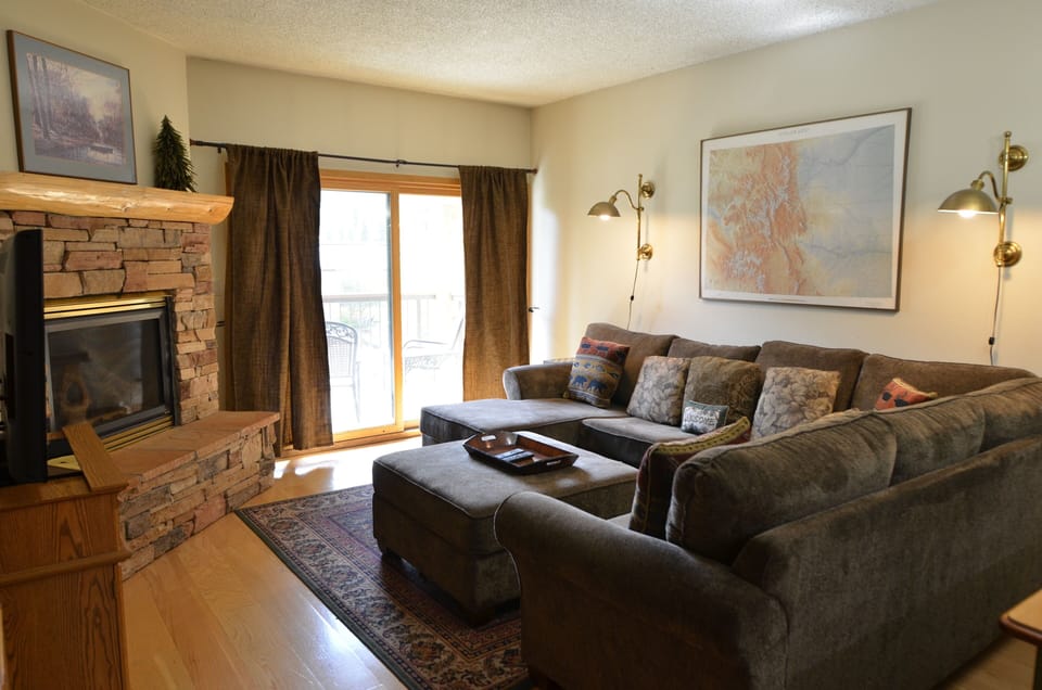Living Room - The living room area has a comfortable sofa, cozy fireplace, and a TV.