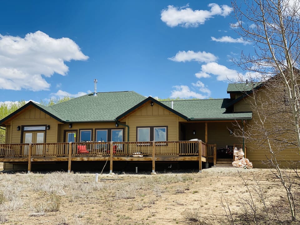 Back of home; deck with furniture and grill