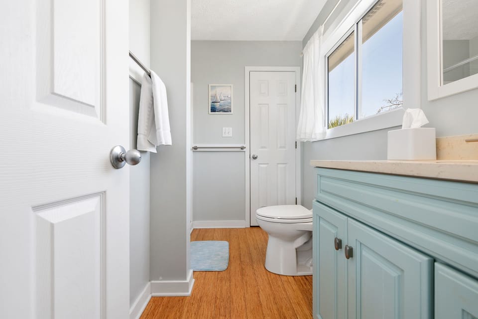 Ensuite bathroom of main level primary bedroom with walk-in shower