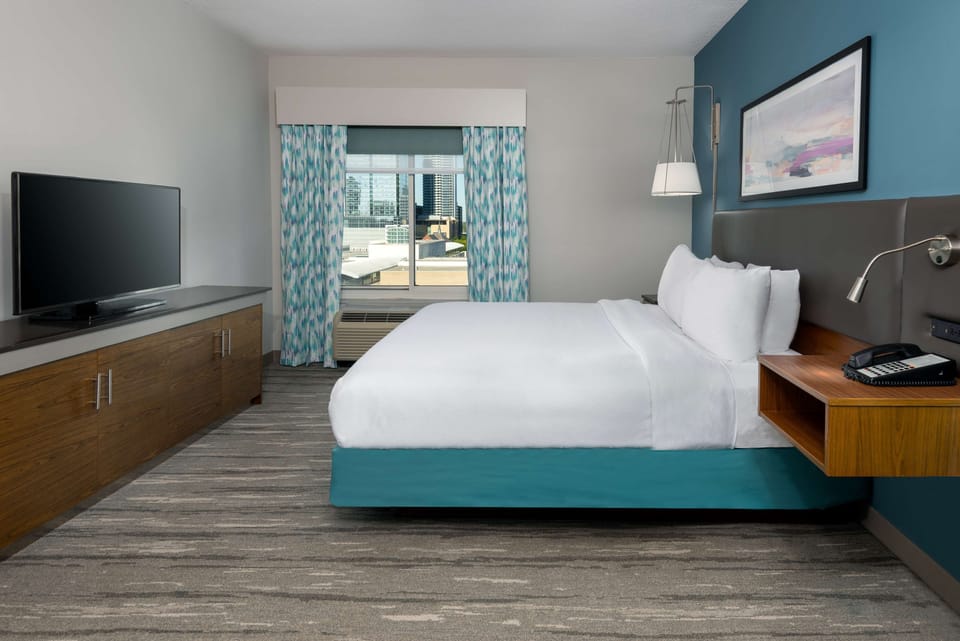 Premium bedding, desk, laptop workspace, blackout drapes