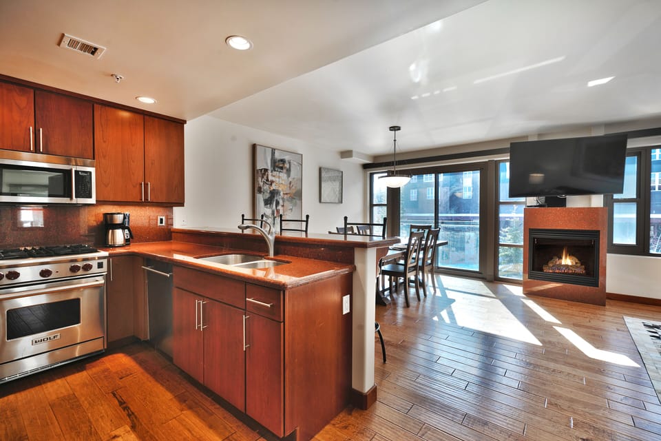 Kitchen bar overlooks the dining area with sliding glass doors for plenty of natural light