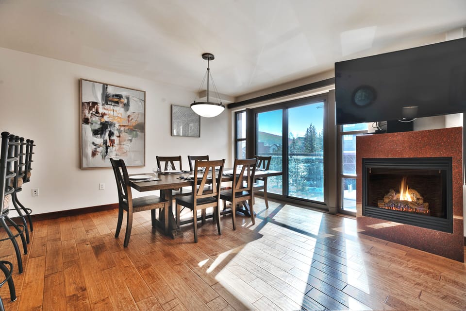 Hardwood floors throughout the dining room, living area, and kitchen