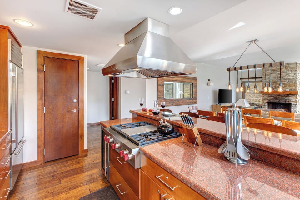 Lowell 402 kitchen island with range and stainless steel range hood.