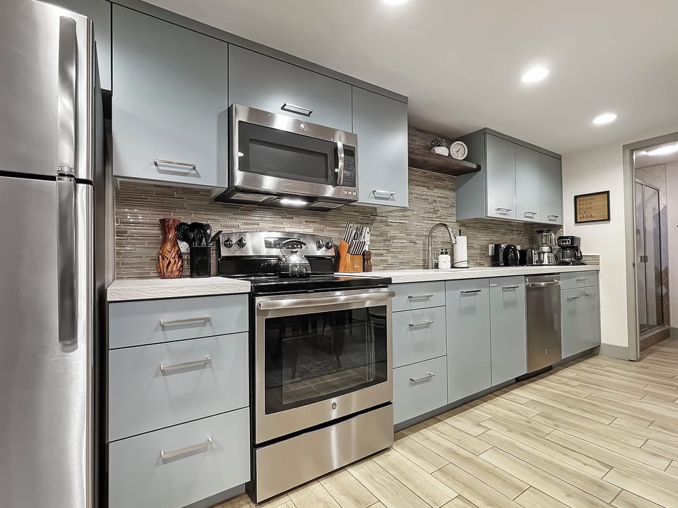The kitchen boasts sleek stainless steel appliances, combining style and functionality for all your cooking needs.