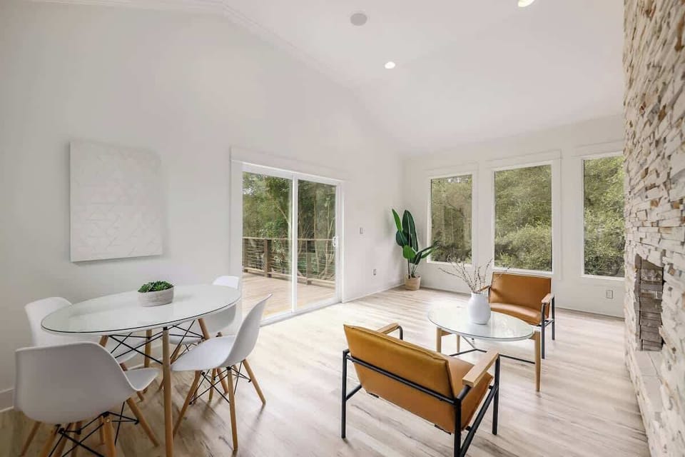 Another seating area + table leading to the second floor deck and yard.