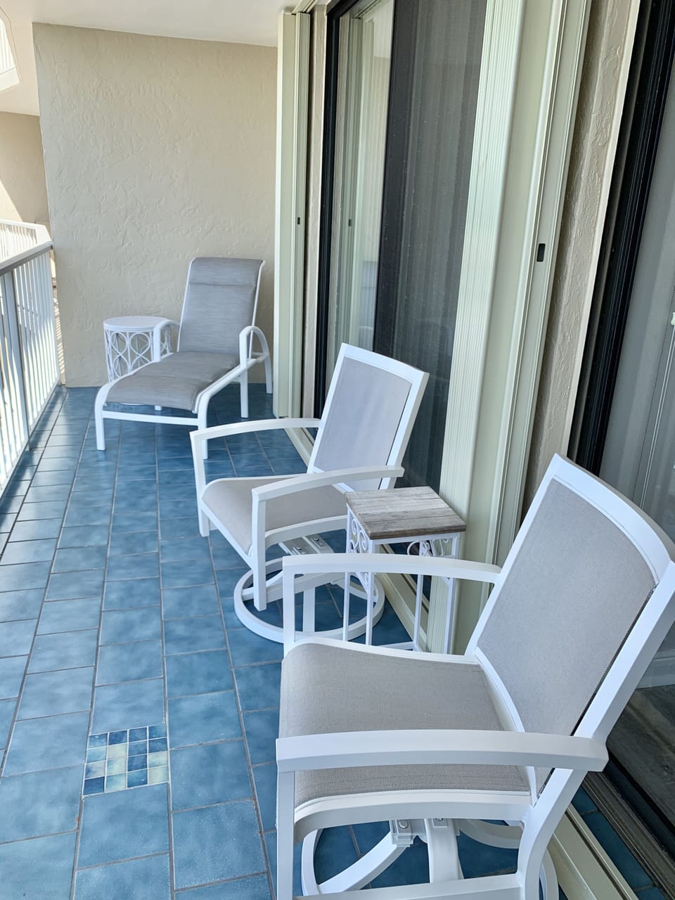 Comfortable swivel chairs & lounge chair on balcony 