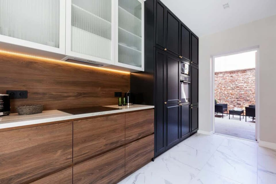 Another view of the kitchen, showing its minimalist design with ample counter space.