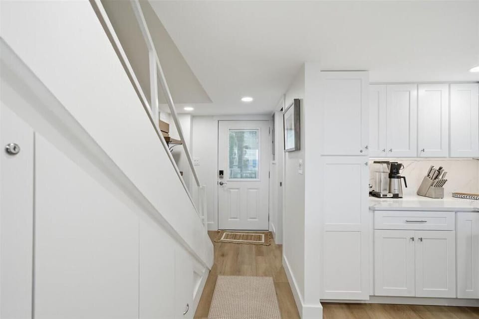 Bright, airy kitchen with sleek white cabinetry and modern appliances