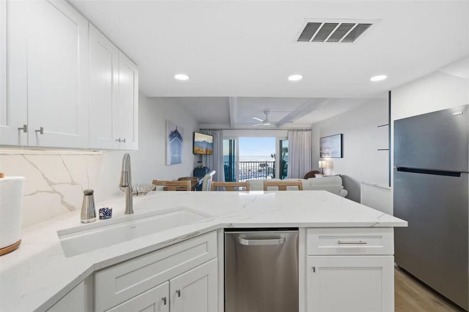 Bright, open kitchen flowing into cozy living area