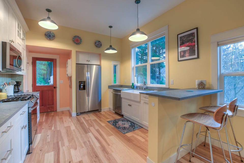 The door at the back of the kitchen leads to the deck with BBQ, picnic table.