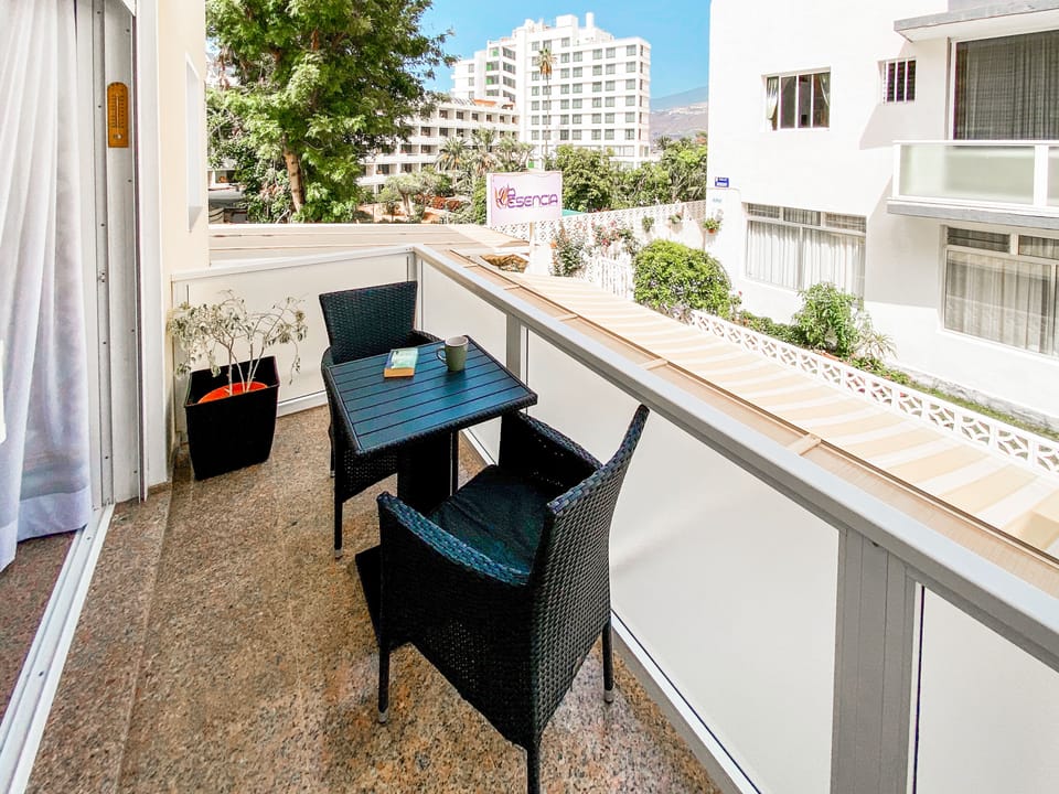 Balcony with a view of the neighboring hotel gardens and mountains