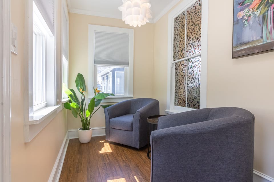 Comfortable seating for two in our enclosed porch.