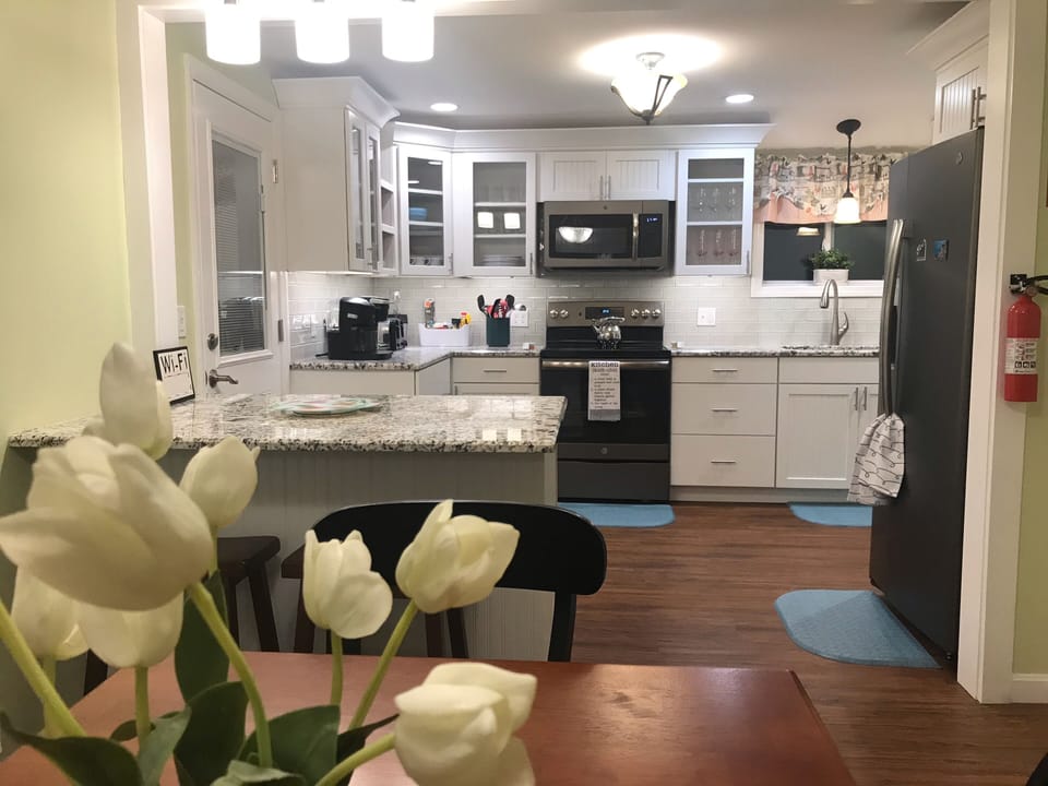 A view of the kitchen from the dining table. 