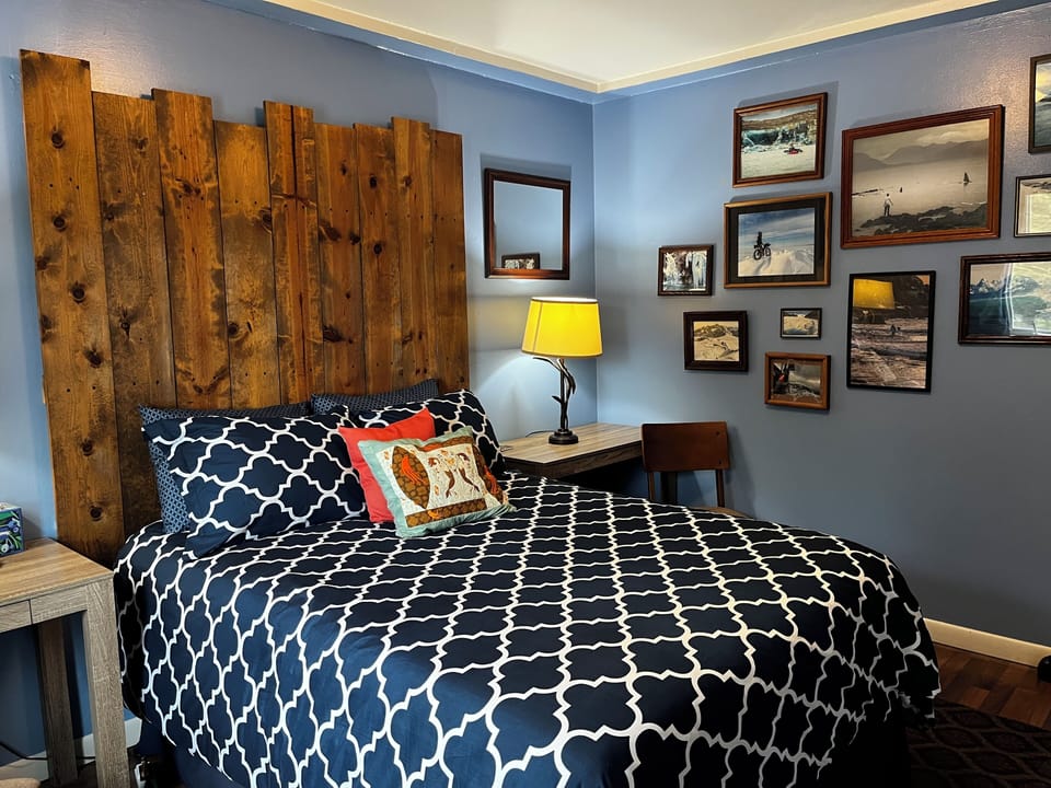 Full size bed in the Bedroom. Photos taken by local artists. 