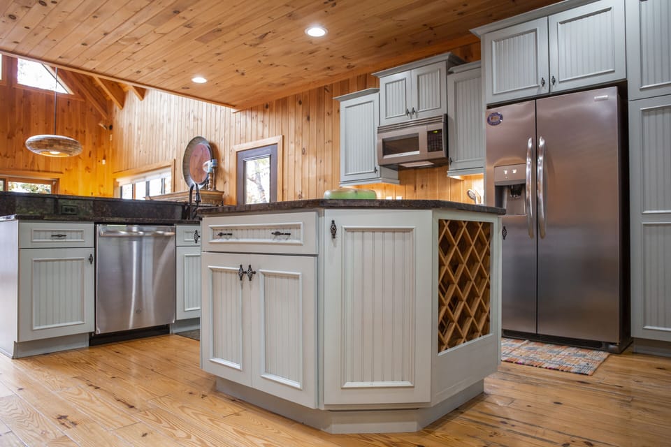 Kitchen w/large island with built in drink fridge; seating at kitchen counter