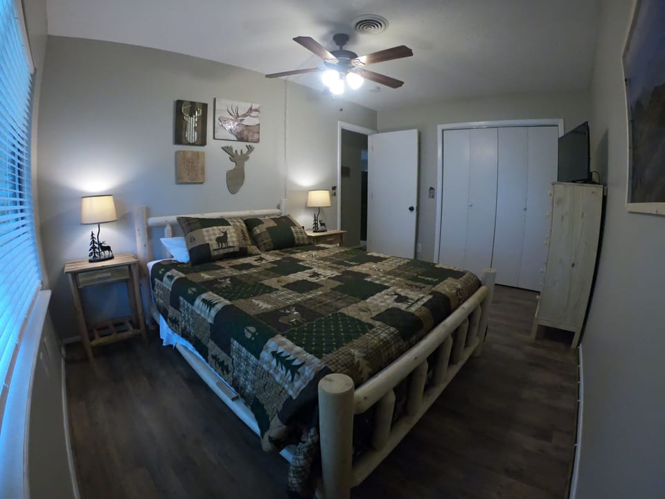 elk bedroom with queen bed and TV