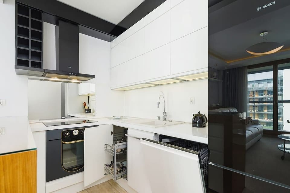 The sleek design of the kitchenette blending seamlessly with the living area.