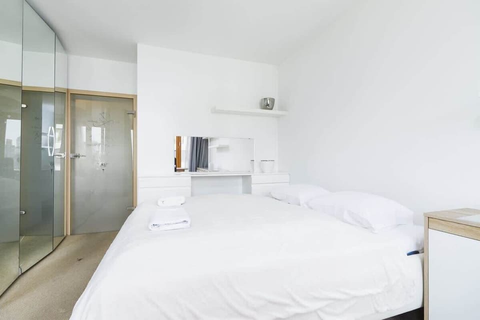 Natural light floods the bedroom, creating a serene environment. 