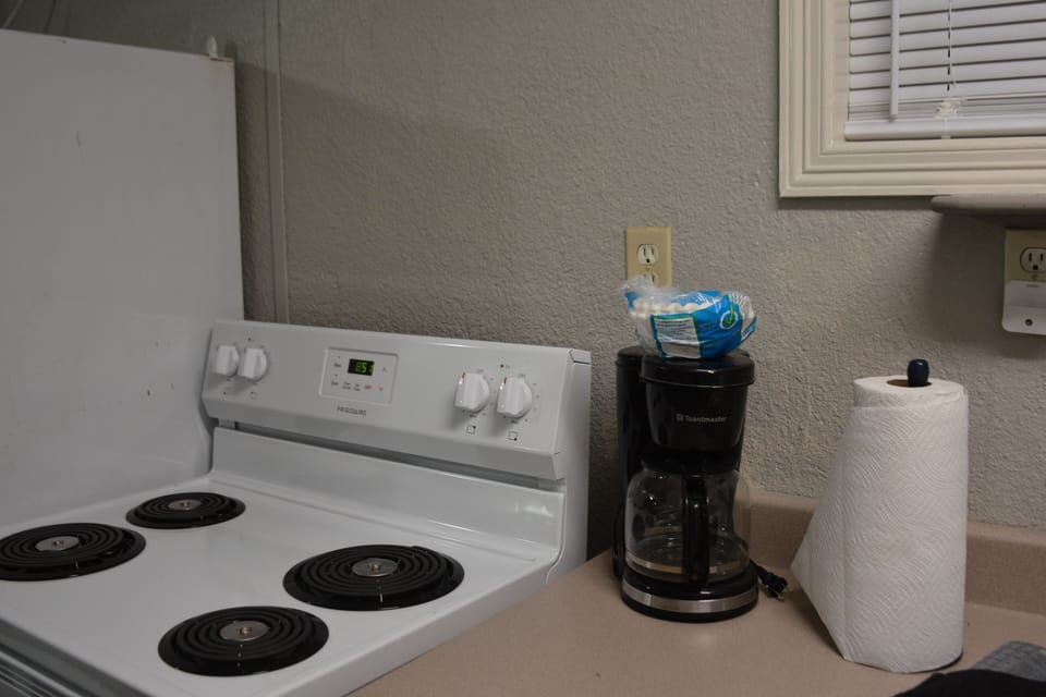 Coffee maker provided as well as a variety of pots, pans dishes and silverware.
