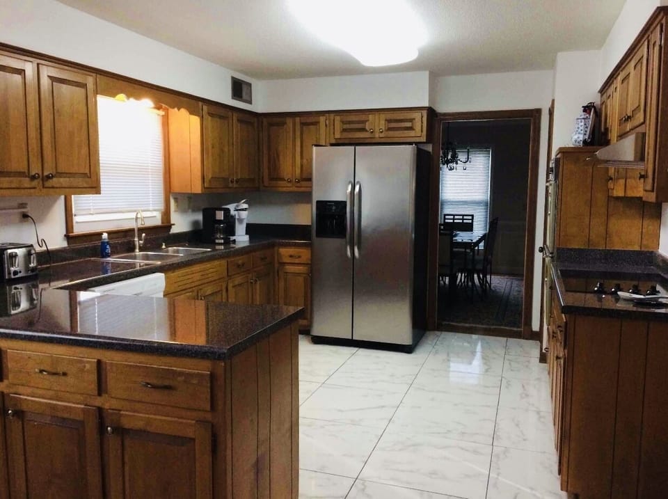 Full kitchen with pots, pans, utensils, and spices for basic cooking.  