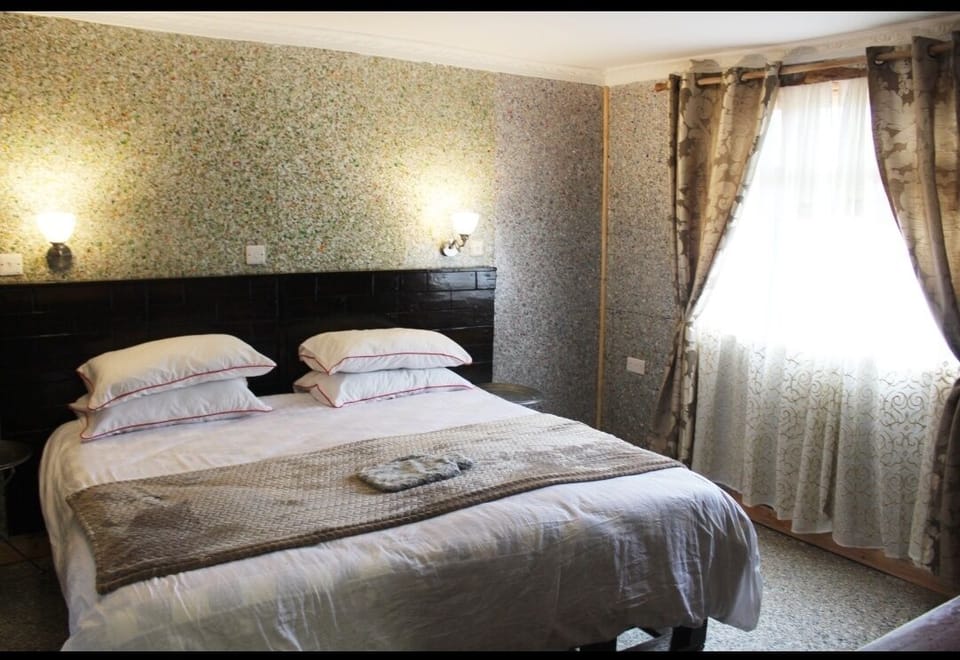 Desk, iron/ironing board, bed sheets