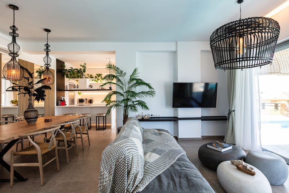 The open plan space is consisted of the kitchen, dining table and sitting area.