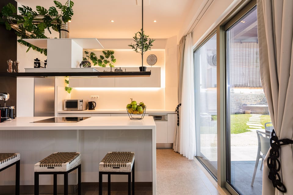 The kitchen provides direct access to the outdoor dining table.