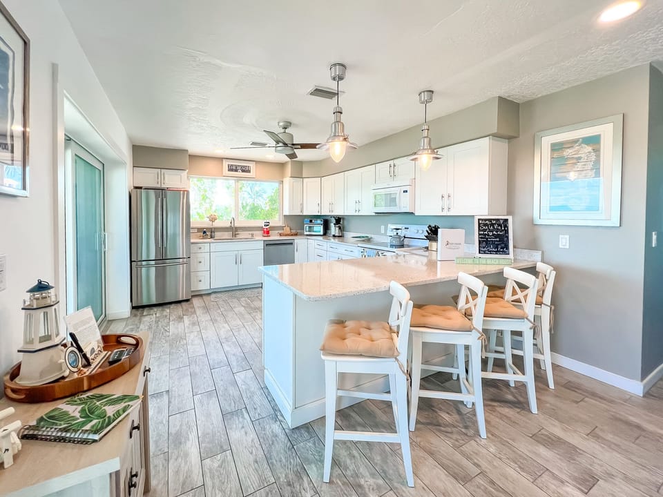 Island seating for 4 and slider to porch for outdoor dining.