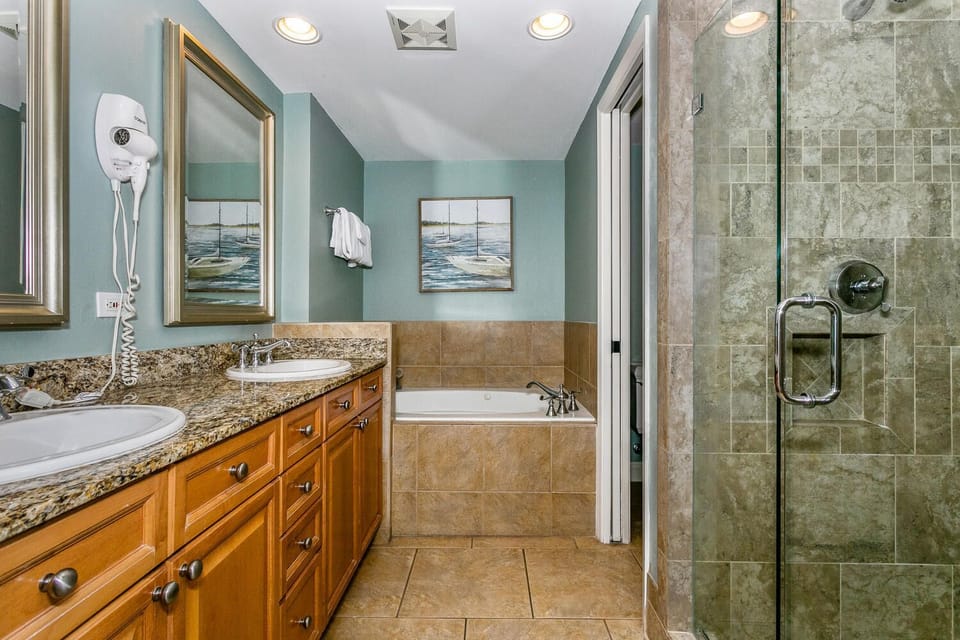 Relax in your private spa-like bathroom, complete with a soaking tub, spacious walk-in shower, and dual vanity—perfect for unwinding after a day at the beach.