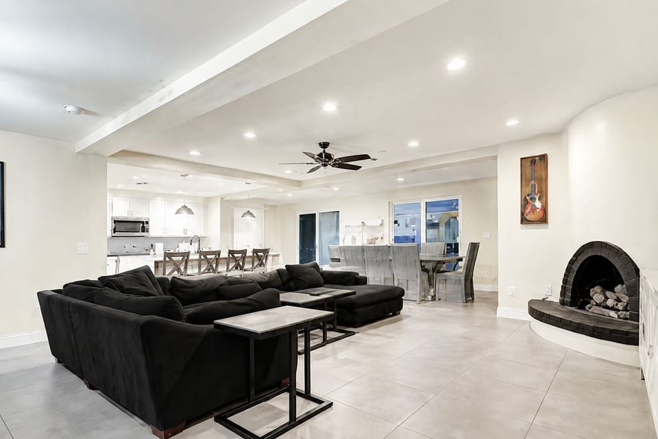 Modern great room design with gas fireplace and european tile floor.