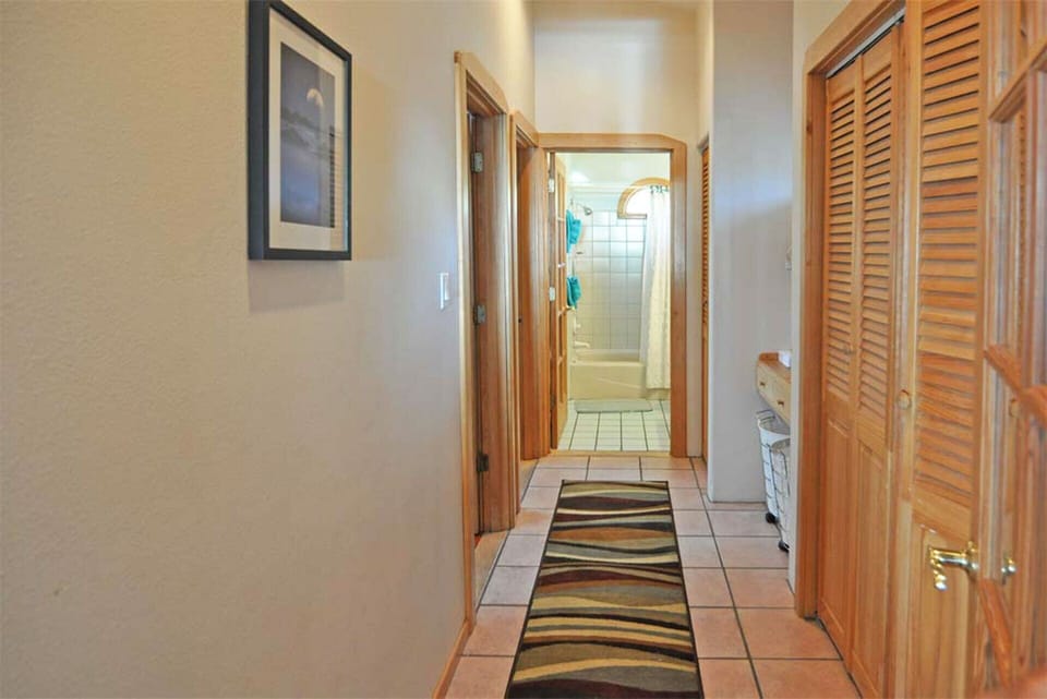 Hallway to bedroom #2 and #3 with common bathroom at end of hallway 