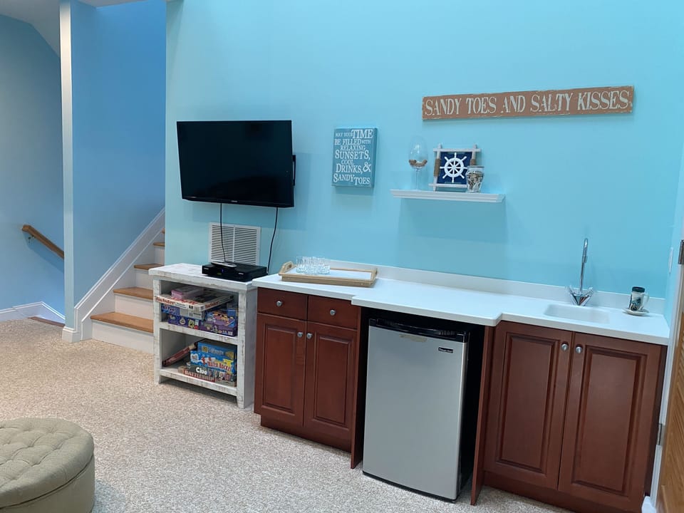 Family room bar, fridge, TV, and board games 
