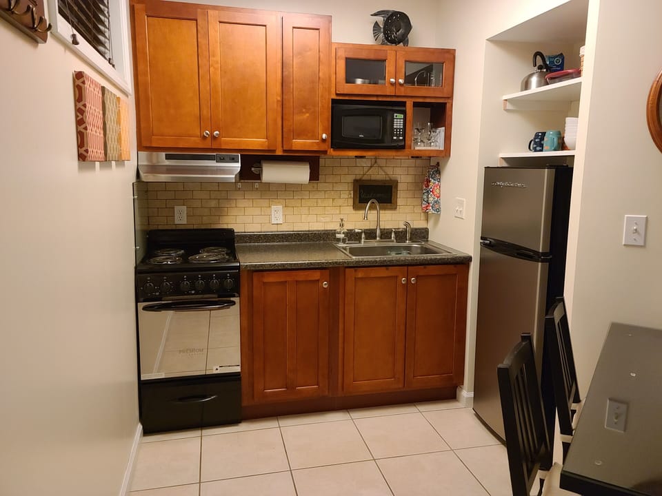 Kitchen featuring stove and mid-size fridge