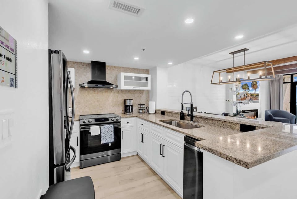 New Kitchen with Black stainless steel appliances, vented hood, induction cooktop w/air fryer, microwave, toaster, all utensils and more.