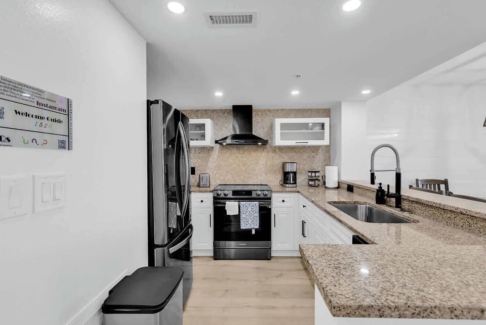 New Kitchen with Black stainless steel appliances, vented hood, induction cooktop w/air fryer, microwave, toaster, all utensils and more.