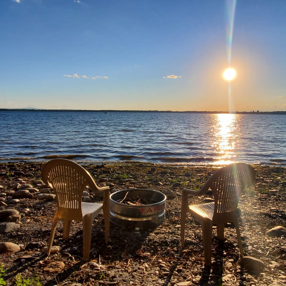 Waterfront fire pit and chairs.