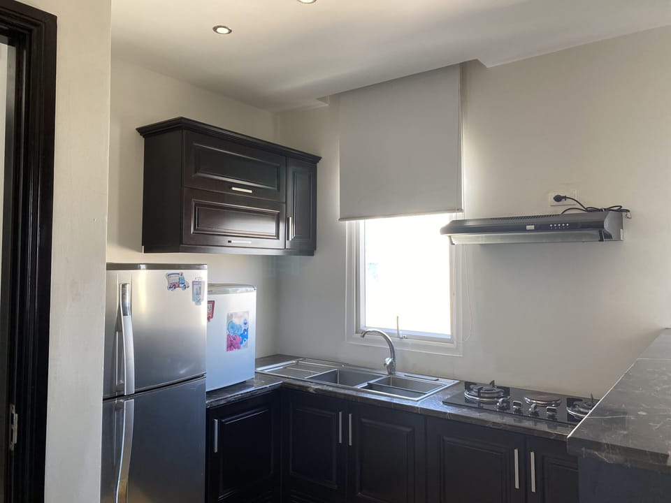 Apartment, 1 King Bed | Private kitchen | Fridge, electric kettle