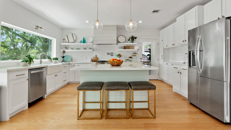 Open kitchen with eat in island for 3 is perfect for the littles!