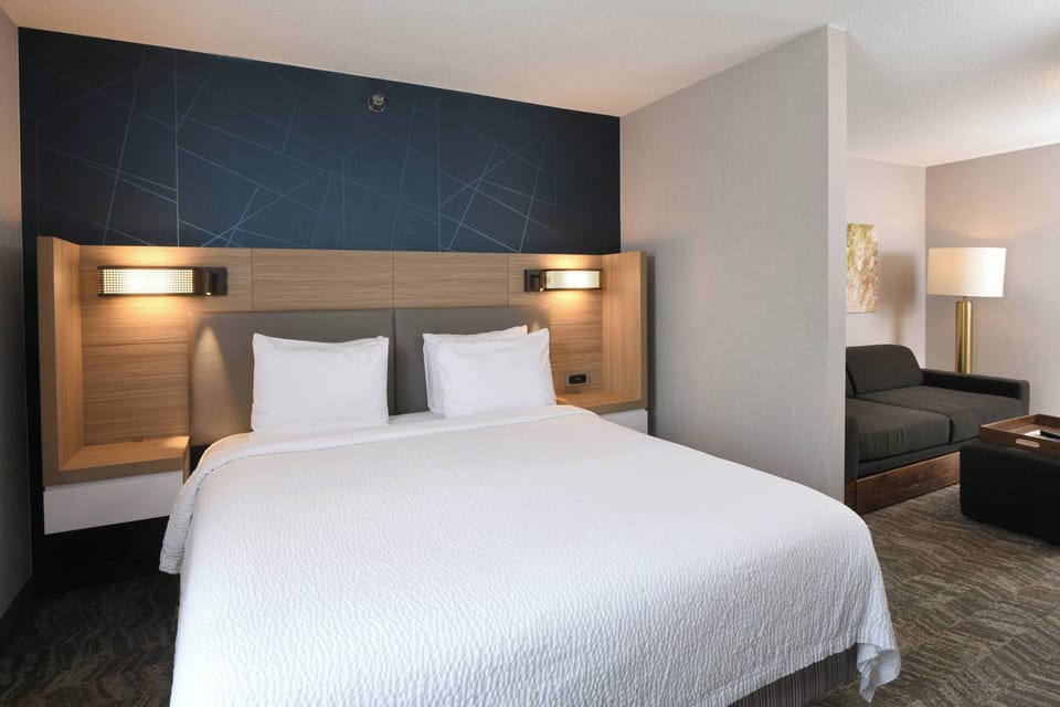 Premium bedding, desk, laptop workspace, blackout drapes